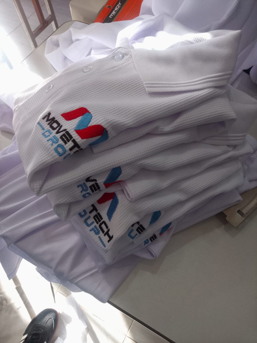 Company logo embroidered on white polo shirts, made in Nairobi